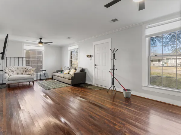 a living room with furniture gym equipment and a window