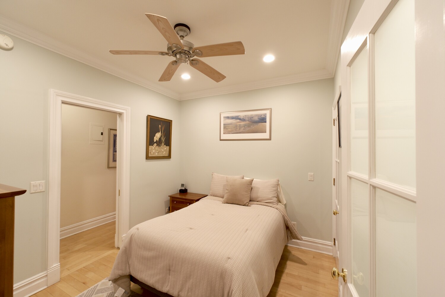 311 West 97th Street, Unit 2W Manhattan, NY 10025 - Photo 10 of 15 a bedroom with a bed and a chandelier