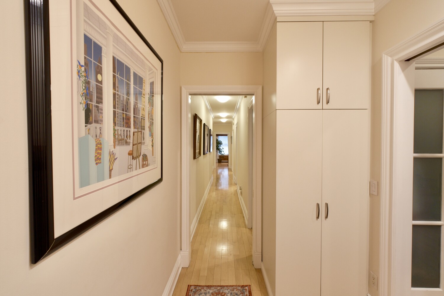 311 West 97th Street, Unit 2W Manhattan, NY 10025 - Photo 6 of 15 a view of a hallway with wooden floor and staircase