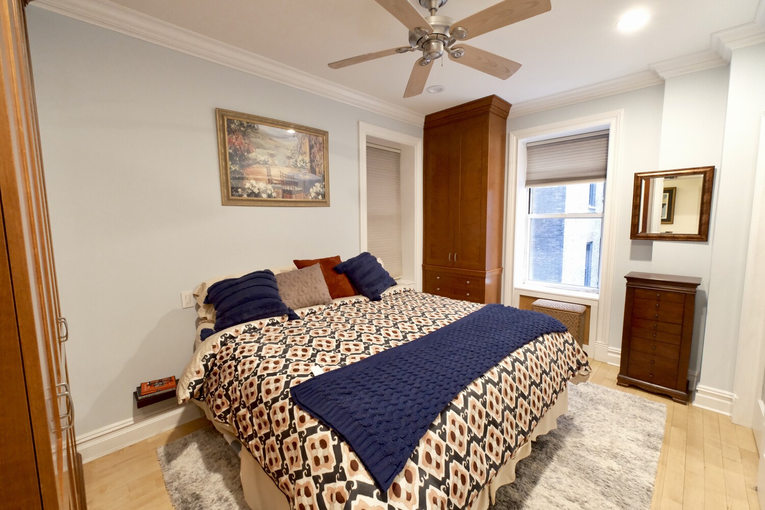 311 West 97th Street, Unit 2W Manhattan, NY 10025 - Photo 7 of 15 a bedroom with a bed and a chandelier