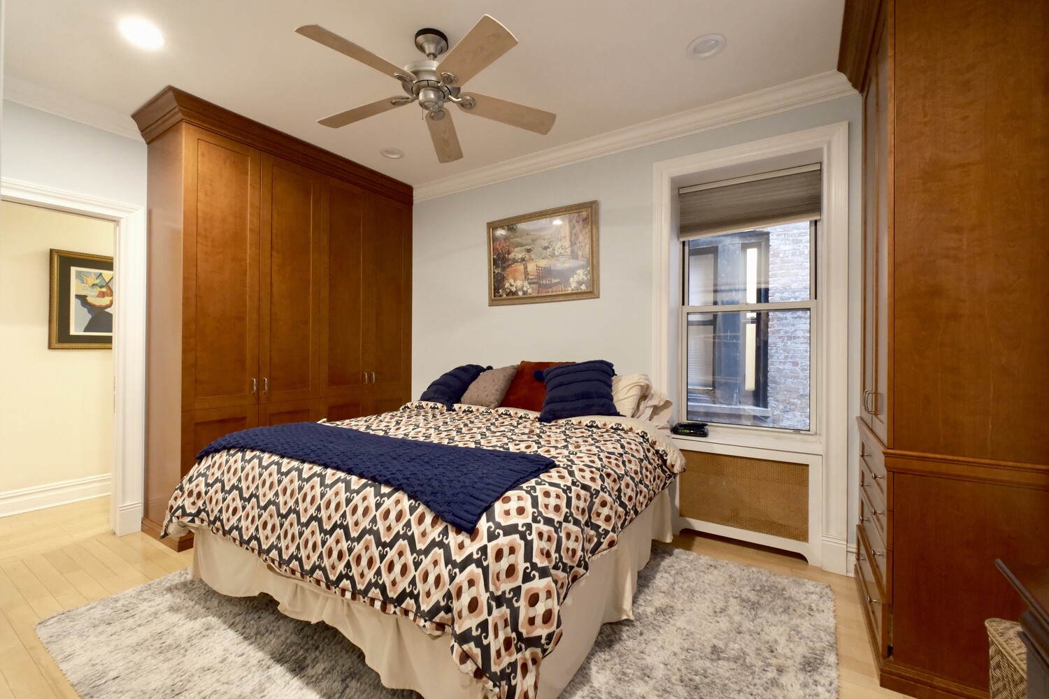 311 West 97th Street, Unit 2W Manhattan, NY 10025 - Photo 8 of 15 a bedroom with a large bed chandelier and a window