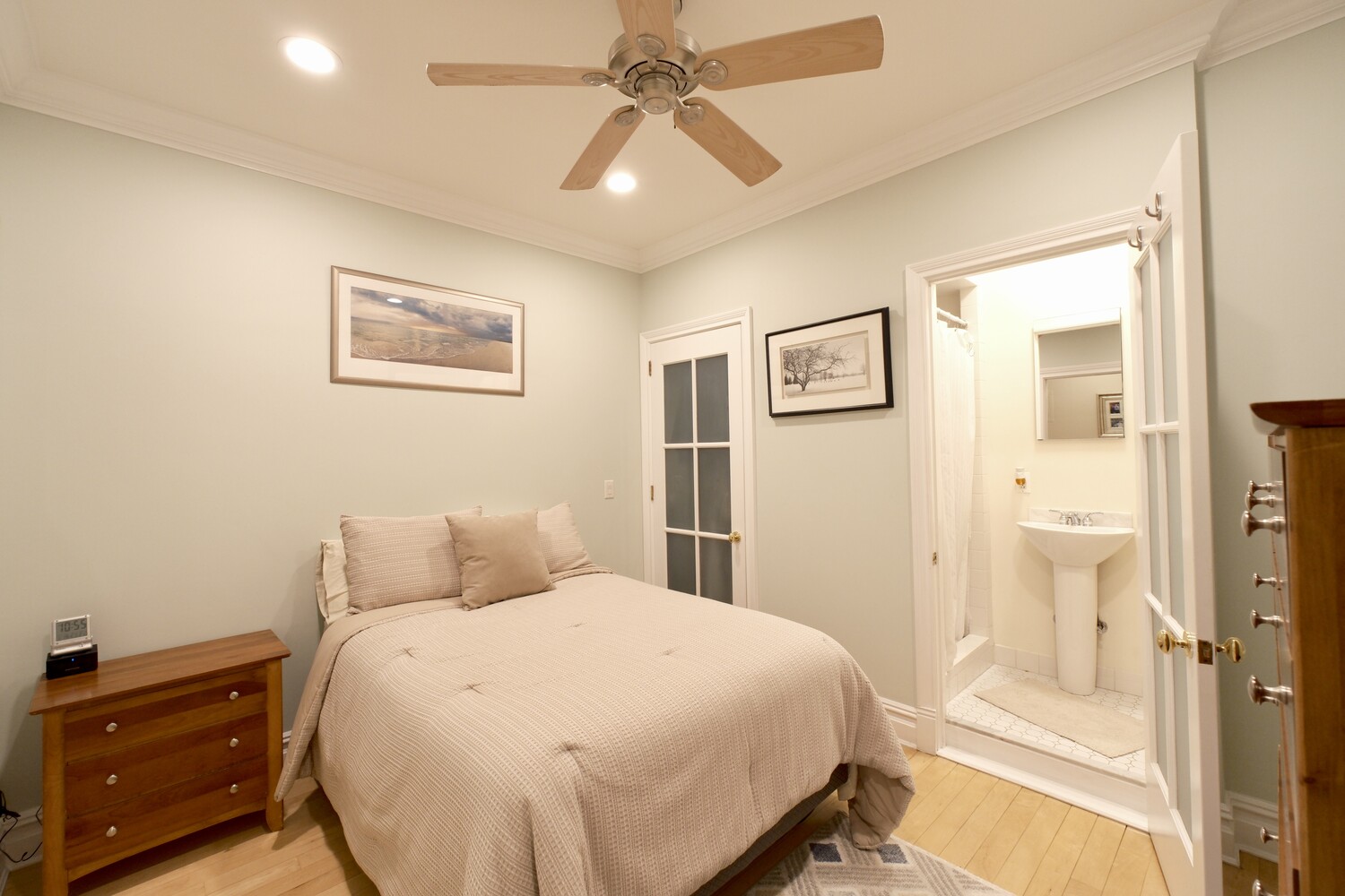 311 West 97th Street, Unit 2W Manhattan, NY 10025 - Photo 9 of 15 a bedroom with a bed and a chandelier