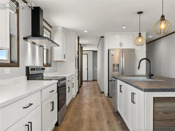 a kitchen with stainless steel appliances a sink stove and refrigerator