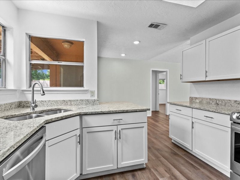 6631 Ambler Drive Spring, TX 77379 - Photo 6 of 37 a kitchen with granite countertop white cabinets and a sink