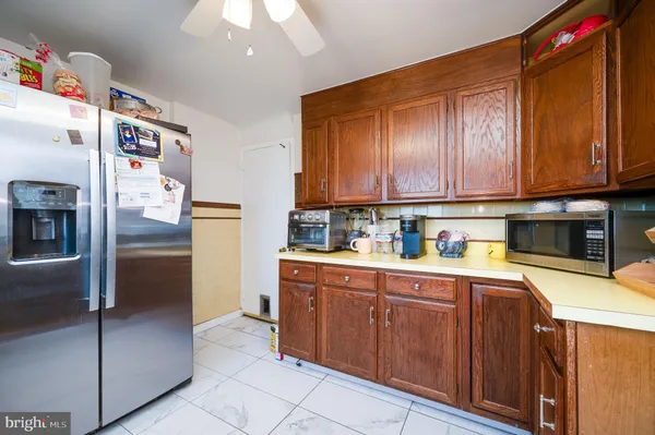 a kitchen with stainless steel appliances granite countertop a refrigerator and a stove top oven