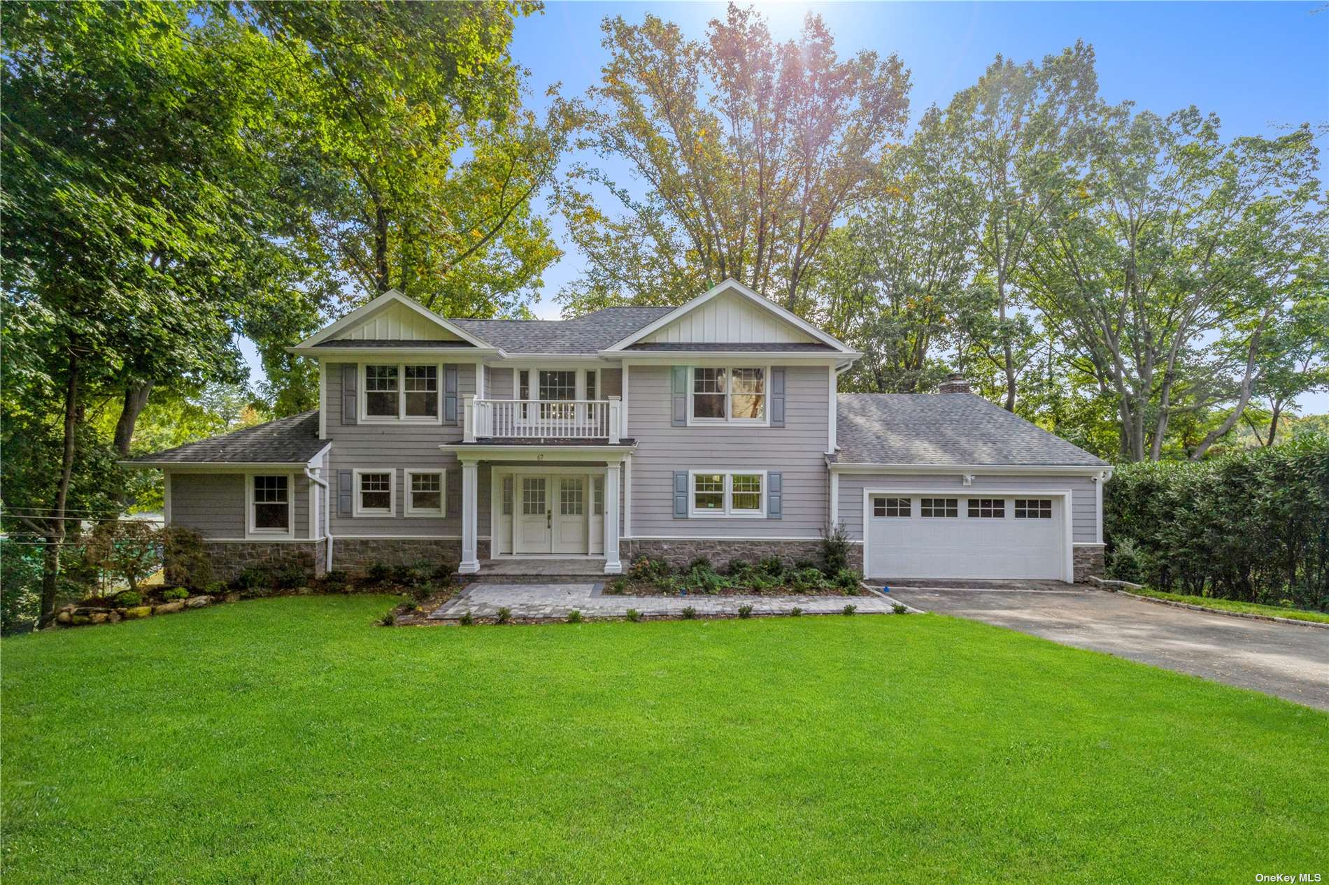 67 Dianas Trail Roslyn, NY 11576 - Photo 1 of 1 a front view of a house with a garden and trees
