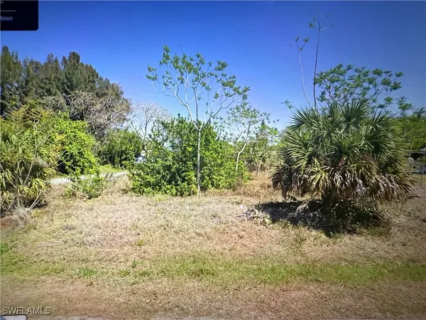 a view of water heater and room with yard