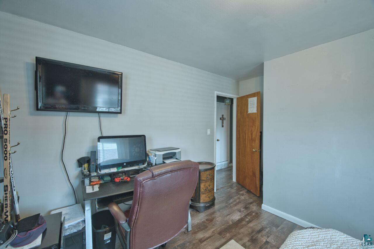 329 Wyandotte Road Hoyt Lakes, MN 55750 - Photo 14 of 52 Interior room featuring wood-finish flooring, light gray wall paint, and a wall-mounted flat-screen display