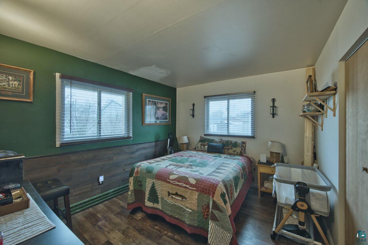 329 Wyandotte Road Hoyt Lakes, MN 55750 - Photo 16 of 52 Room featuring wood-finish flooring and two windows with blinds