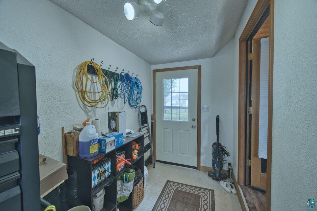 329 Wyandotte Road Hoyt Lakes, MN 55750 - Photo 30 of 52 Entryway featuring a white paneled door with windowpanes, recessed ceiling lighting, textured white walls, and wood-trim doorways