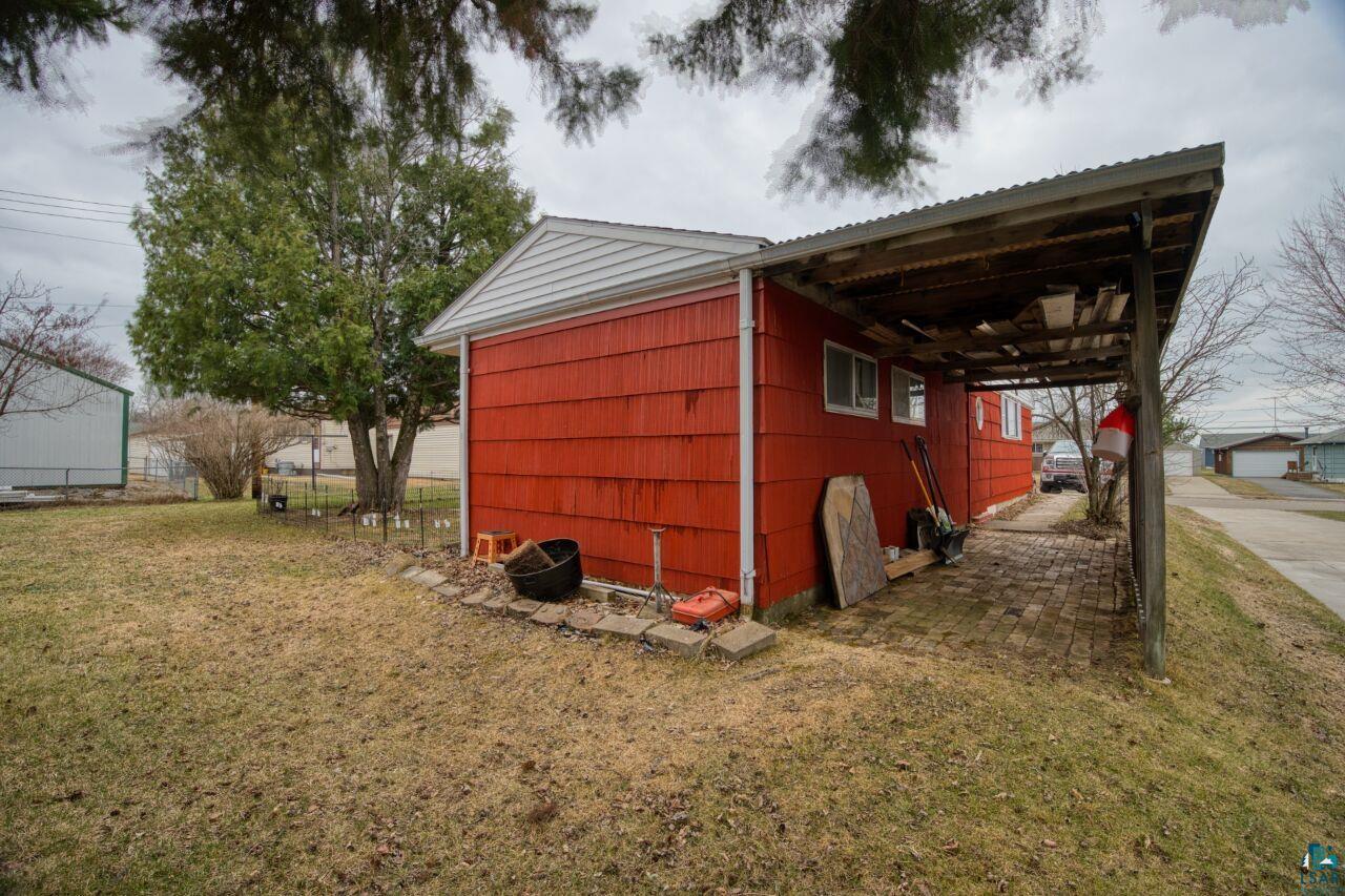 329 Wyandotte Road Hoyt Lakes, MN 55750 - Photo 38 of 52 Red-sided structure with a white gable roof and a covered brick-paved patio