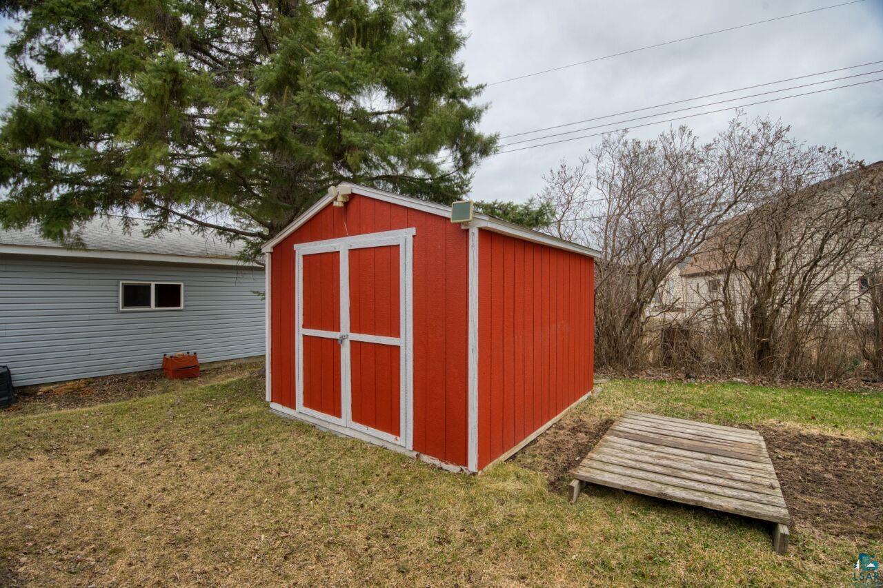 329 Wyandotte Road Hoyt Lakes, MN 55750 - Photo 40 of 52 Red storage shed with white trim and double doors