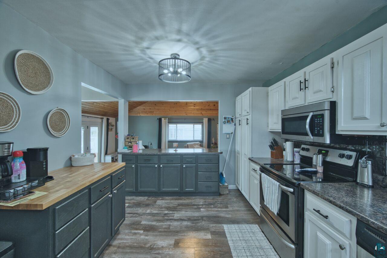 329 Wyandotte Road Hoyt Lakes, MN 55750 - Photo 4 of 52 Spacious kitchen featuring wood-finish flooring and a central island with dark cabinetry