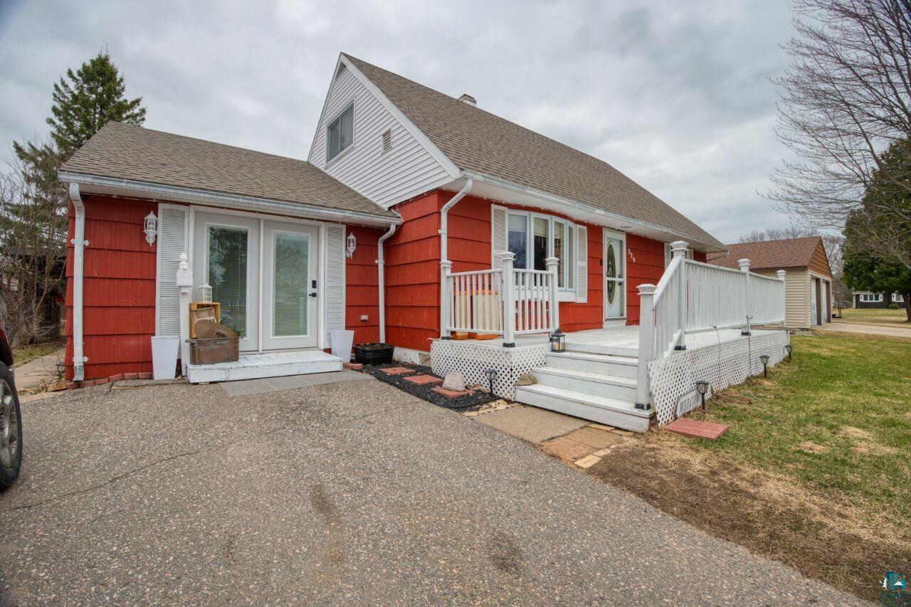 329 Wyandotte Road Hoyt Lakes, MN 55750 - Photo 44 of 52 Exterior featuring red horizontal siding with white trim, a gabled roof, and white shutters