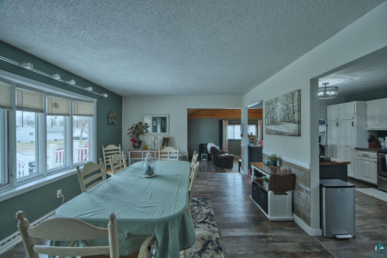 329 Wyandotte Road Hoyt Lakes, MN 55750 - Photo 7 of 52 Spacious dining area featuring wood-finish flooring, ample natural light from multiple windows, and track lighting
