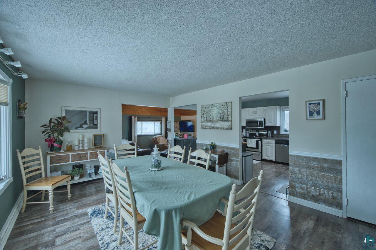 329 Wyandotte Road Hoyt Lakes, MN 55750 - Photo 8 of 52 Spacious dining area with wood-finish flooring and a decorative area rug
