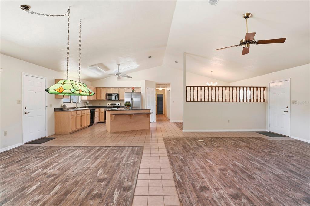 534 Southwest Thorne Lane Fort White, FL 32038 - Photo 16 of 51 a view of a kitchen with kitchen island a stove a wooden floor and a window