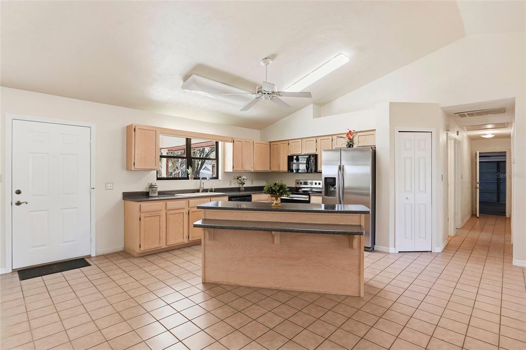 534 Southwest Thorne Lane Fort White, FL 32038 - Photo 17 of 51 a open kitchen with stainless steel appliances granite countertop a refrigerator and a stove top oven
