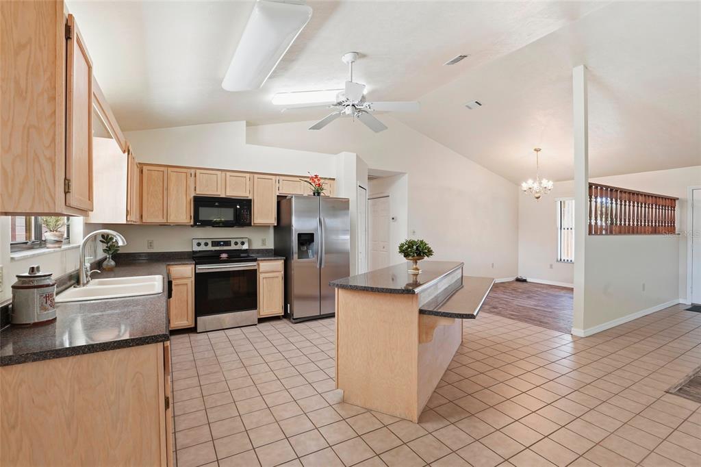 534 Southwest Thorne Lane Fort White, FL 32038 - Photo 18 of 51 a kitchen with stainless steel appliances kitchen island granite countertop a sink and a stove