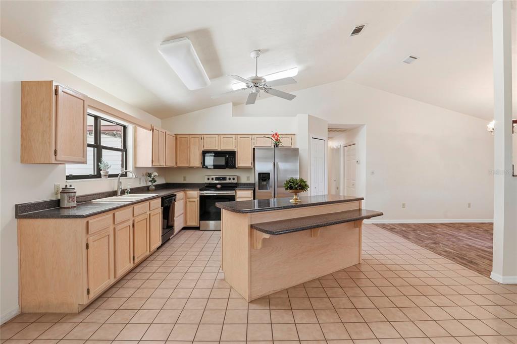 534 Southwest Thorne Lane Fort White, FL 32038 - Photo 19 of 51 a kitchen with stainless steel appliances granite countertop a stove sink and cabinets