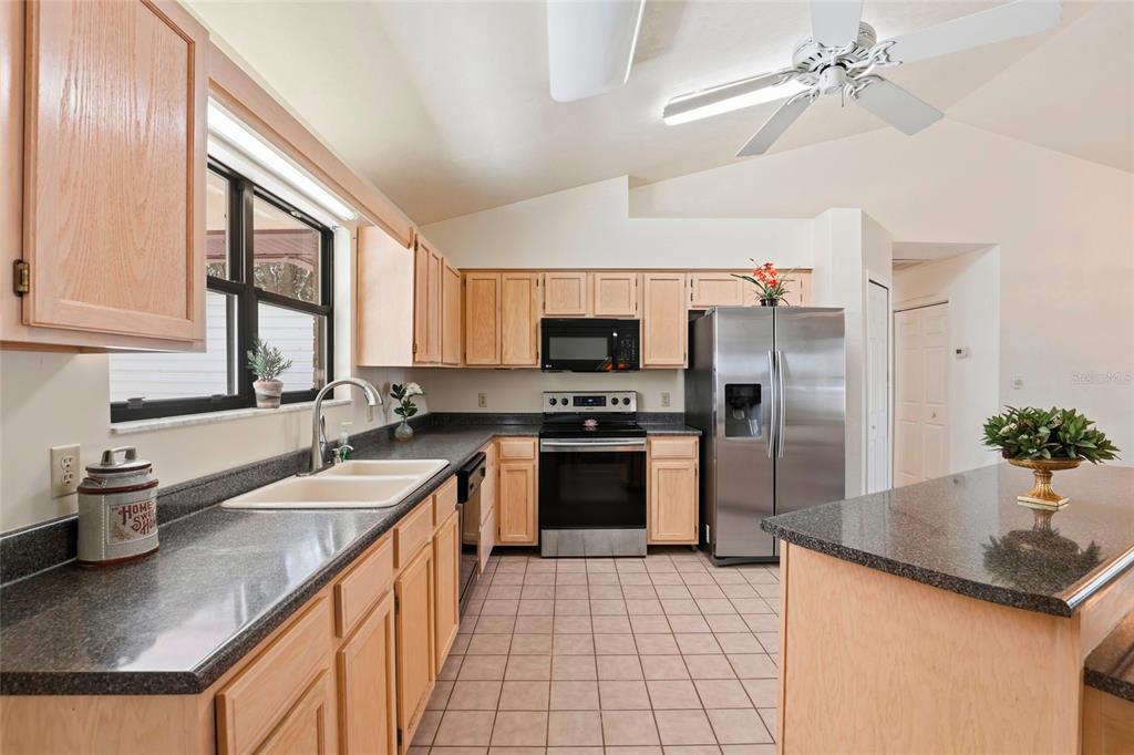 534 Southwest Thorne Lane Fort White, FL 32038 - Photo 20 of 51 a kitchen with stainless steel appliances granite countertop a sink stove and refrigerator