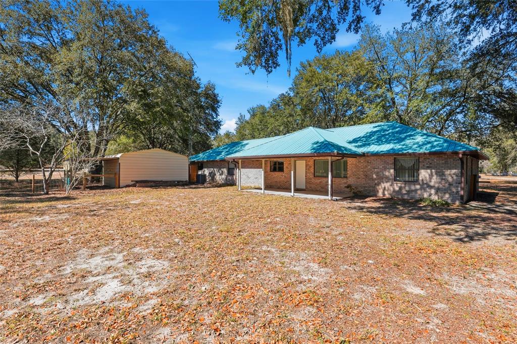 534 Southwest Thorne Lane Fort White, FL 32038 - Photo 42 of 51 a front view of a house with a yard and trees