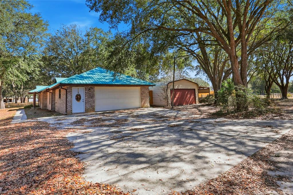 534 Southwest Thorne Lane Fort White, FL 32038 - Photo 43 of 51 a backyard of a house with large trees and wooden fence