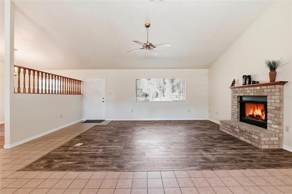 534 Southwest Thorne Lane Fort White, FL 32038 - Photo 8 of 51 an empty room with windows and fireplace