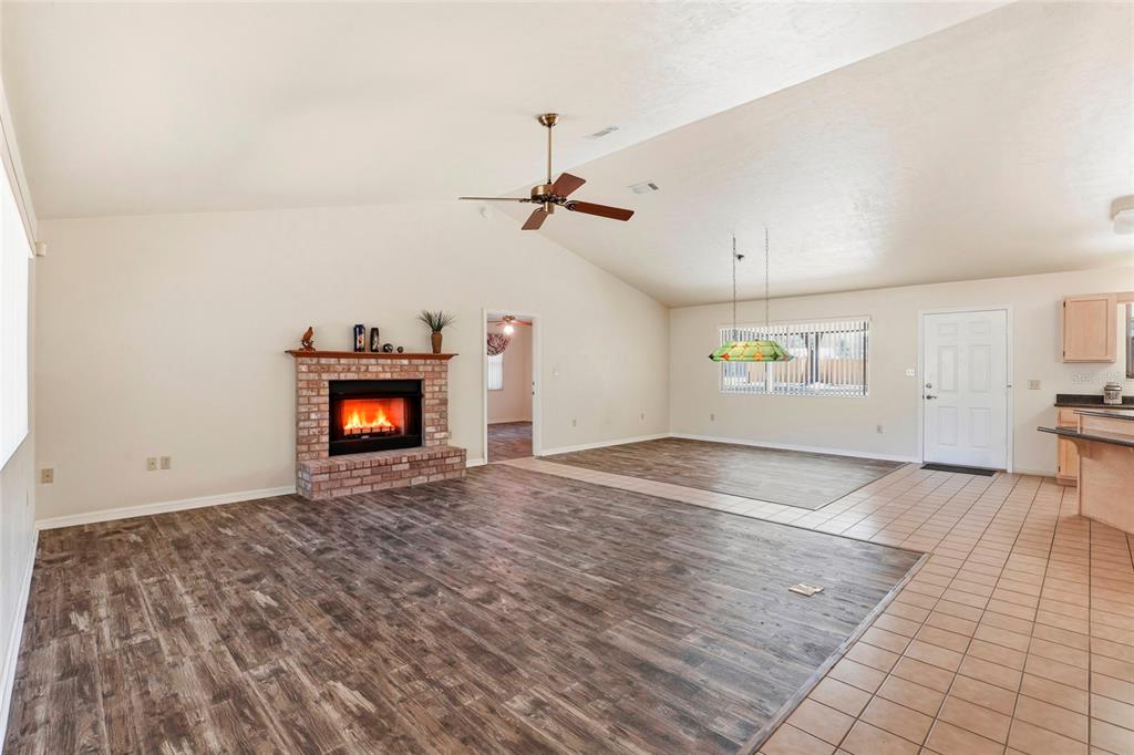 534 Southwest Thorne Lane Fort White, FL 32038 - Photo 10 of 51 a view of empty room with wooden floor and fireplace