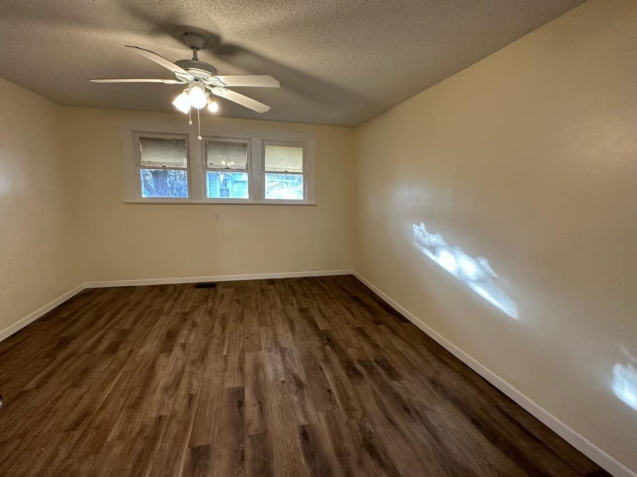 1900 Twigg Street Palatka, FL 32177 - Photo 6 of 10 wooden floor in an empty room with a window