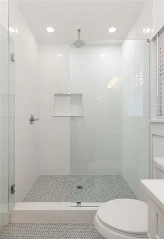 a bathroom with a shower a toilet and a shower