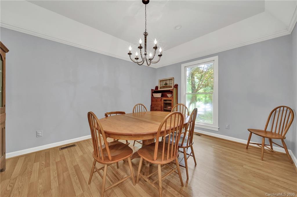 2685 Farmstead Lane, Unit 2685 Fort Mill, SC 29708 - Photo 18 of 30 a view of a dining room with furniture a chandelier and wooden floor