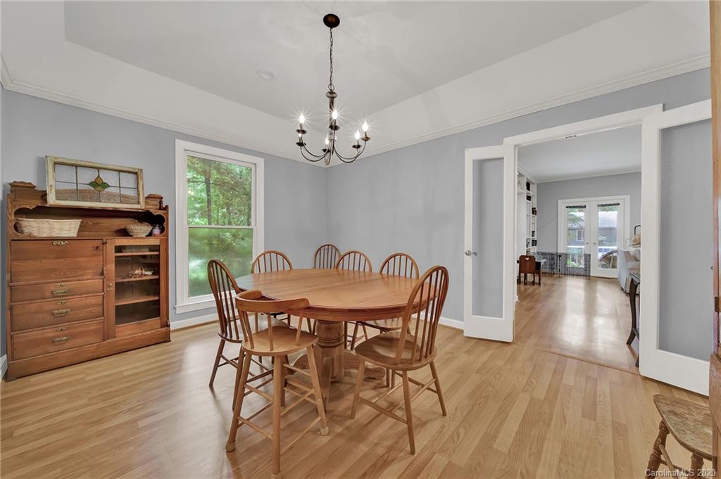 2685 Farmstead Lane, Unit 2685 Fort Mill, SC 29708 - Photo 19 of 30 a view of a dining room with furniture wooden floor and chandelier