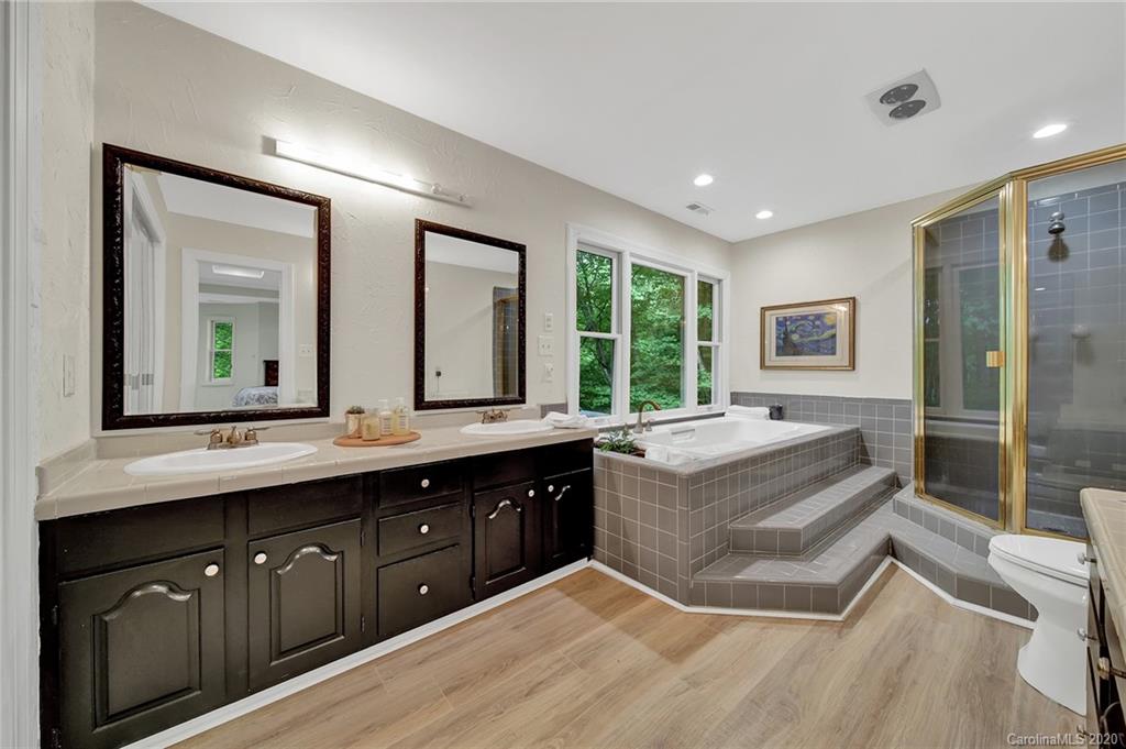 2685 Farmstead Lane, Unit 2685 Fort Mill, SC 29708 - Photo 23 of 30 a spacious bathroom with a double vanity sink a large mirror and a bathtub