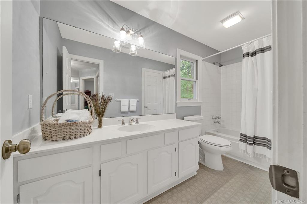 2685 Farmstead Lane, Unit 2685 Fort Mill, SC 29708 - Photo 26 of 30 a bathroom with a double vanity sink toilet mirror and bathtub