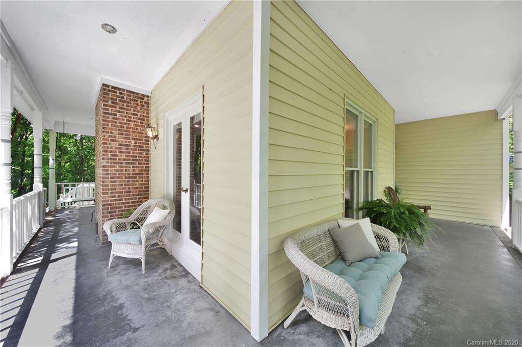 2685 Farmstead Lane, Unit 2685 Fort Mill, SC 29708 - Photo 5 of 30 a view of a porch with chairs and a potted plant