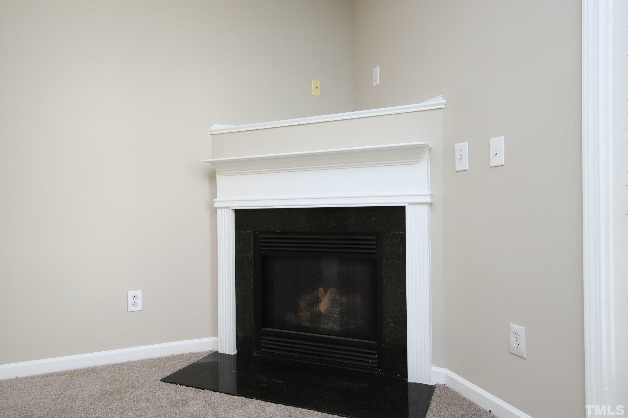 8205 Martello Lane Raleigh, NC 27613 - Photo 11 of 28 a room with a fireplace