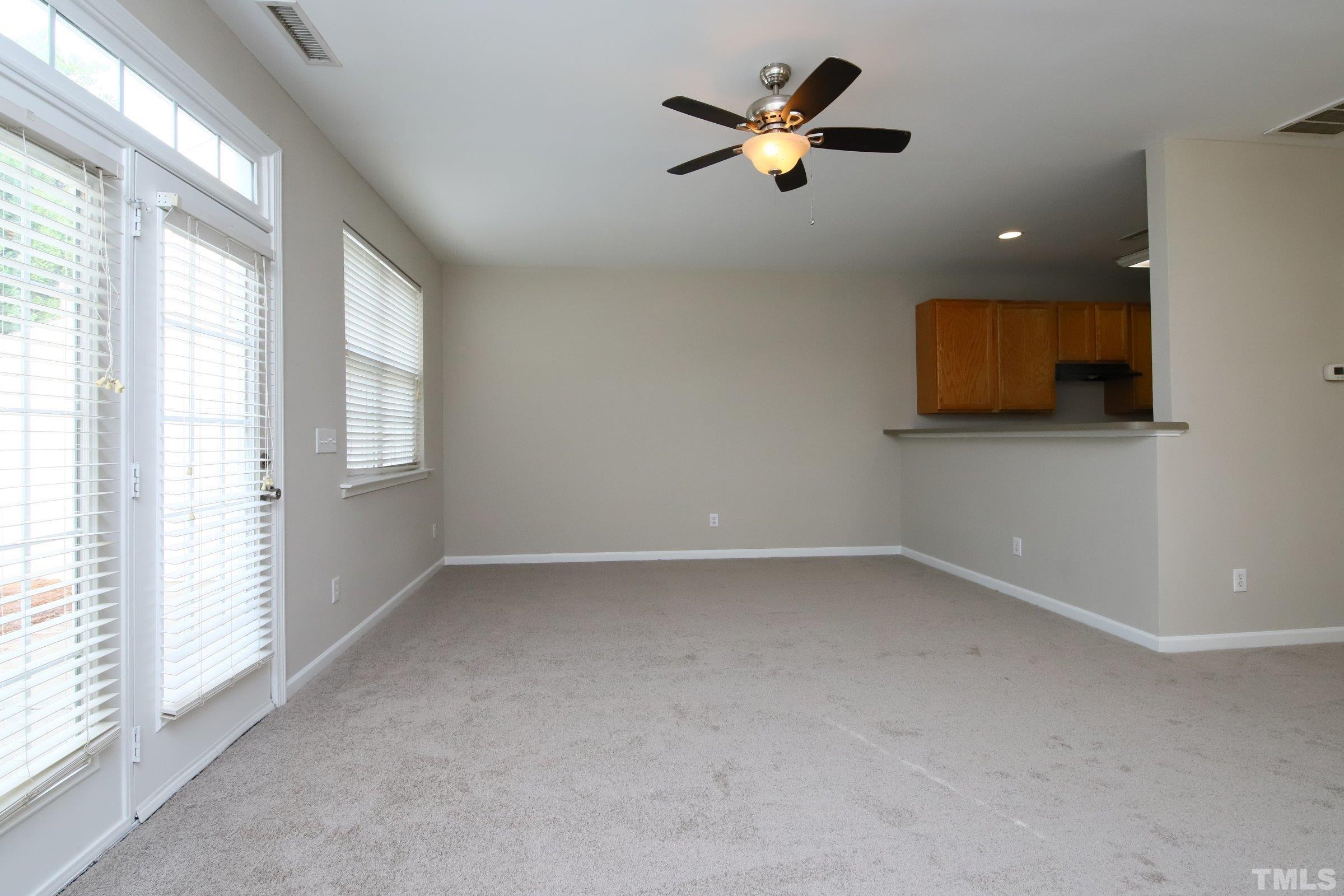 8205 Martello Lane Raleigh, NC 27613 - Photo 12 of 28 wooden floor in an empty room with a window
