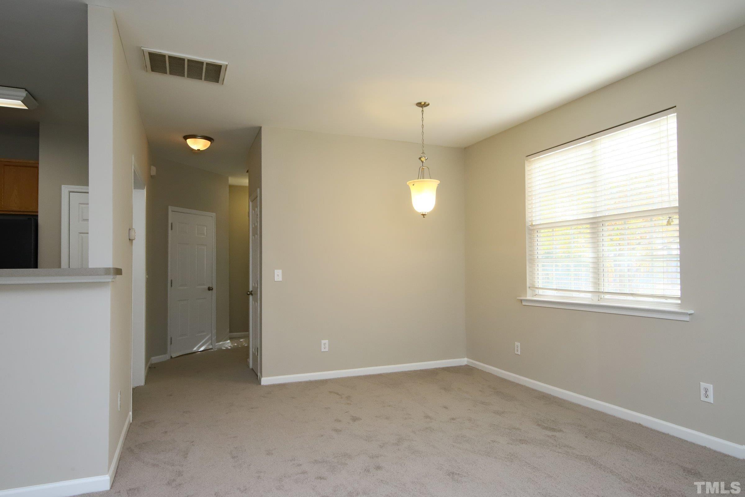 8205 Martello Lane Raleigh, NC 27613 - Photo 13 of 28 an empty room with windows and entrance