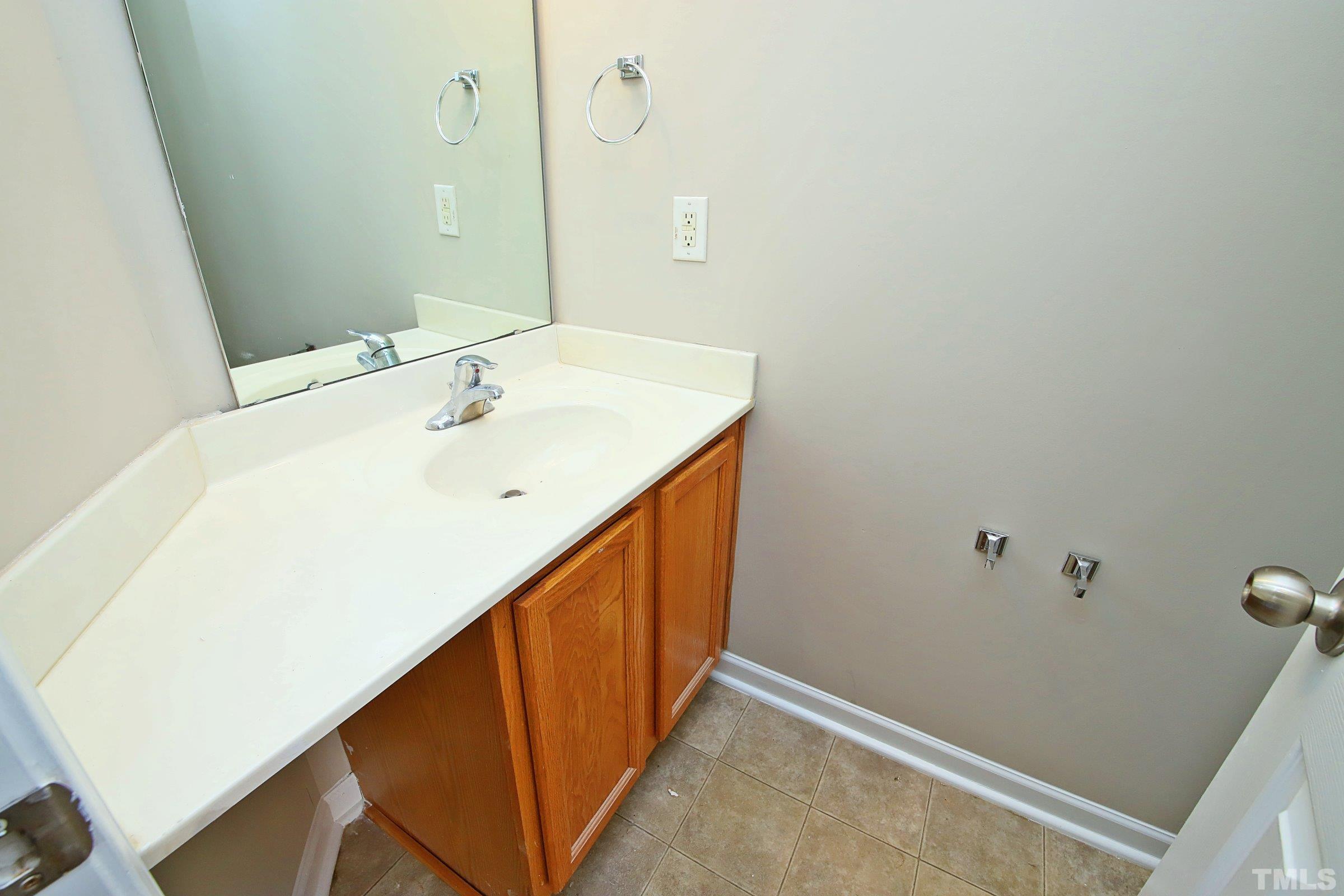 8205 Martello Lane Raleigh, NC 27613 - Photo 14 of 28 a bathroom with a sink and mirror