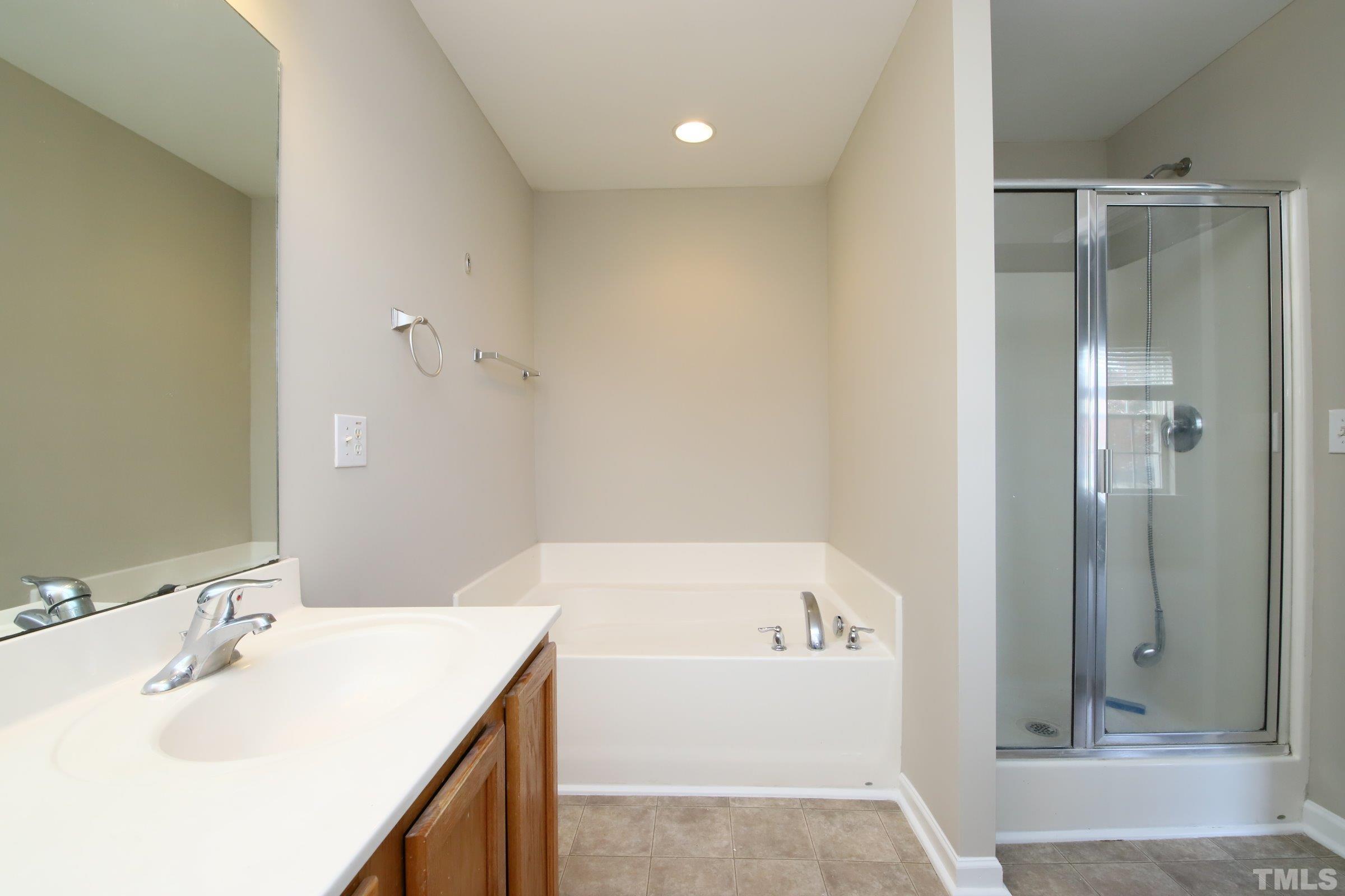 8205 Martello Lane Raleigh, NC 27613 - Photo 16 of 28 a bathroom with a bathtub and a sink