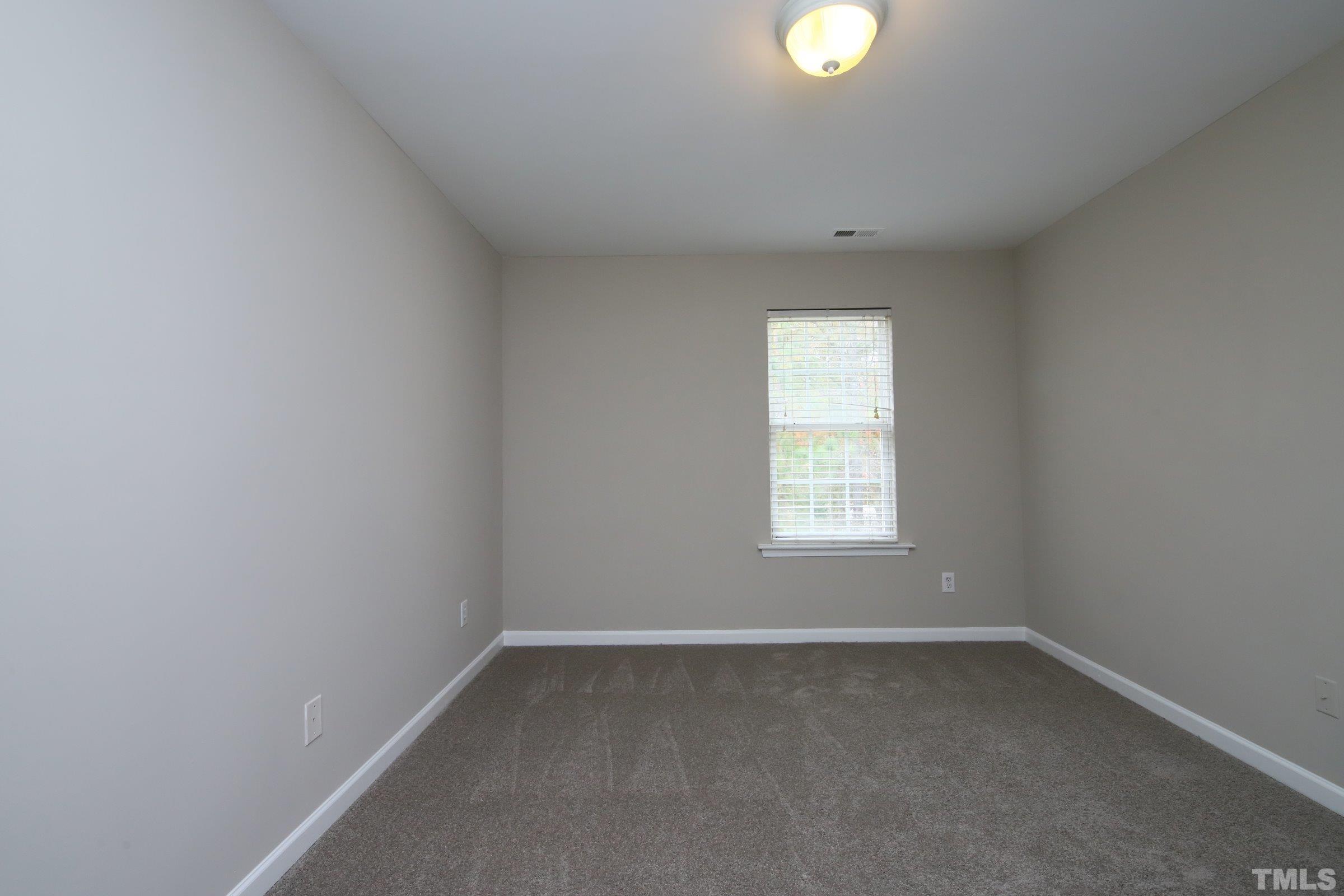 8205 Martello Lane Raleigh, NC 27613 - Photo 19 of 28 an empty room with a window and windows
