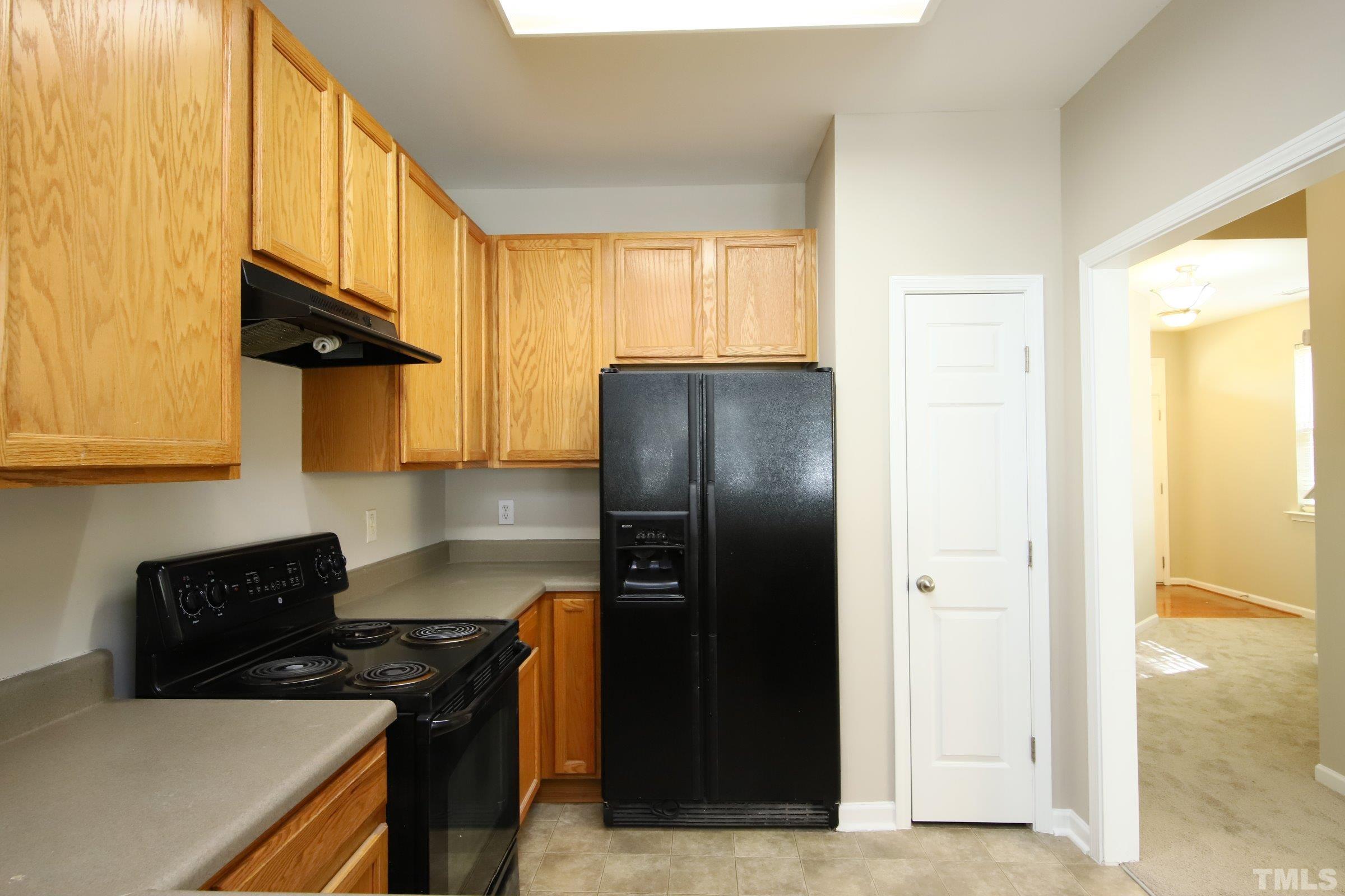 8205 Martello Lane Raleigh, NC 27613 - Photo 3 of 28 a kitchen with stainless steel appliances granite countertop a refrigerator and a stove top oven