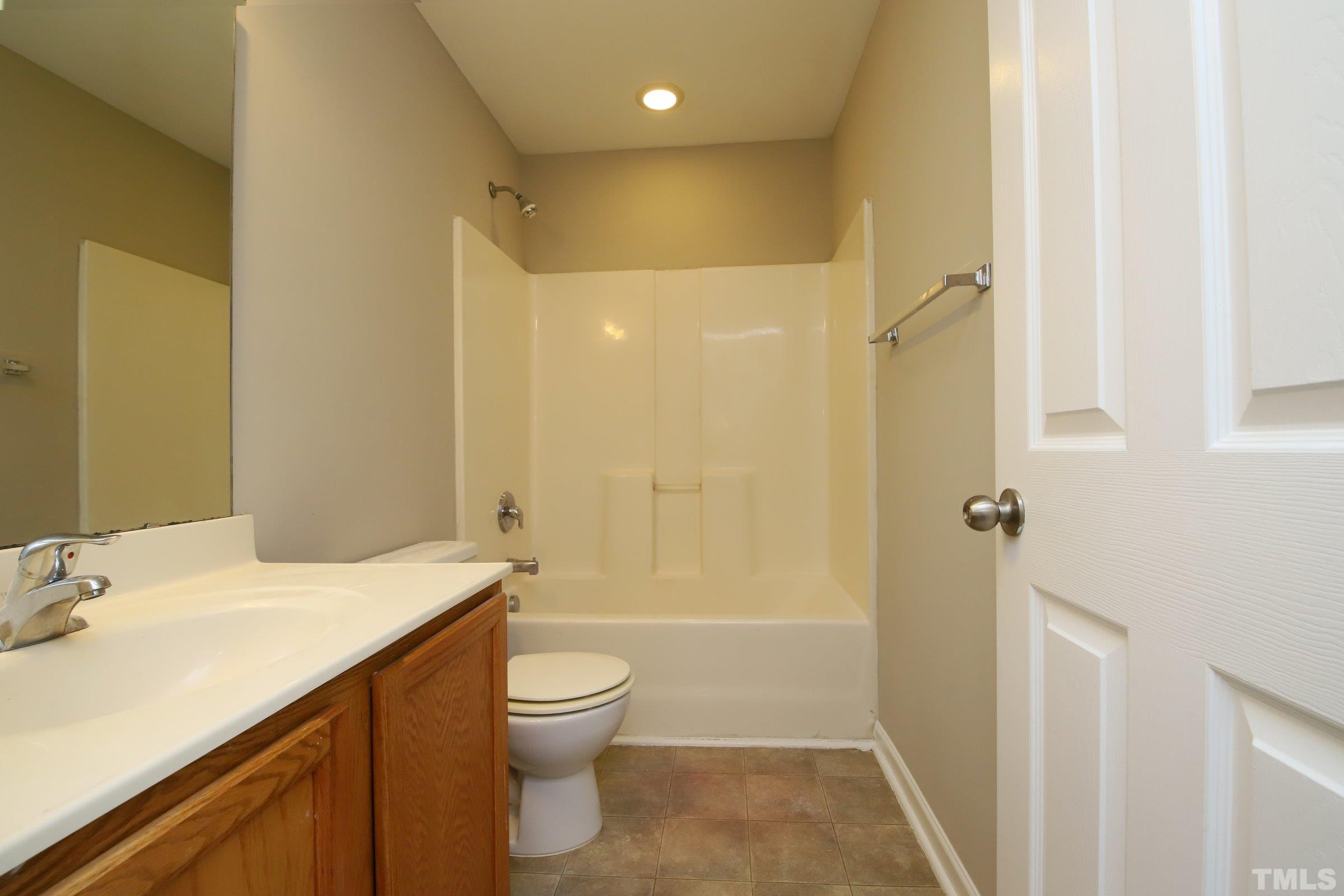 8205 Martello Lane Raleigh, NC 27613 - Photo 23 of 28 a bathroom with a sink a toilet and shower