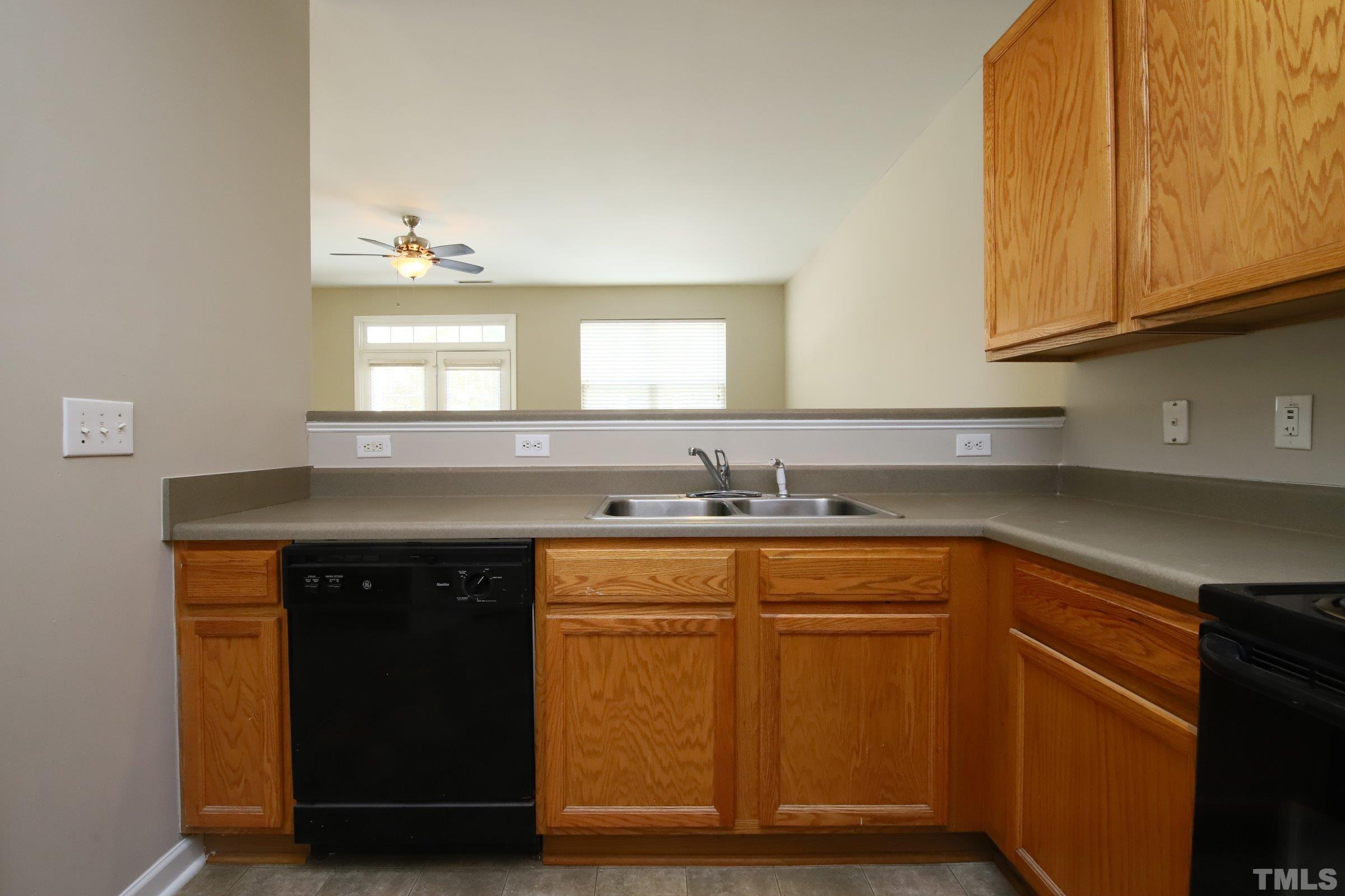 8205 Martello Lane Raleigh, NC 27613 - Photo 5 of 28 a kitchen with stainless steel appliances granite countertop a sink and cabinets