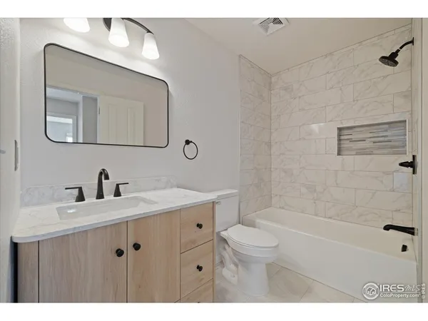a bathroom with a sink a toilet and bathtub