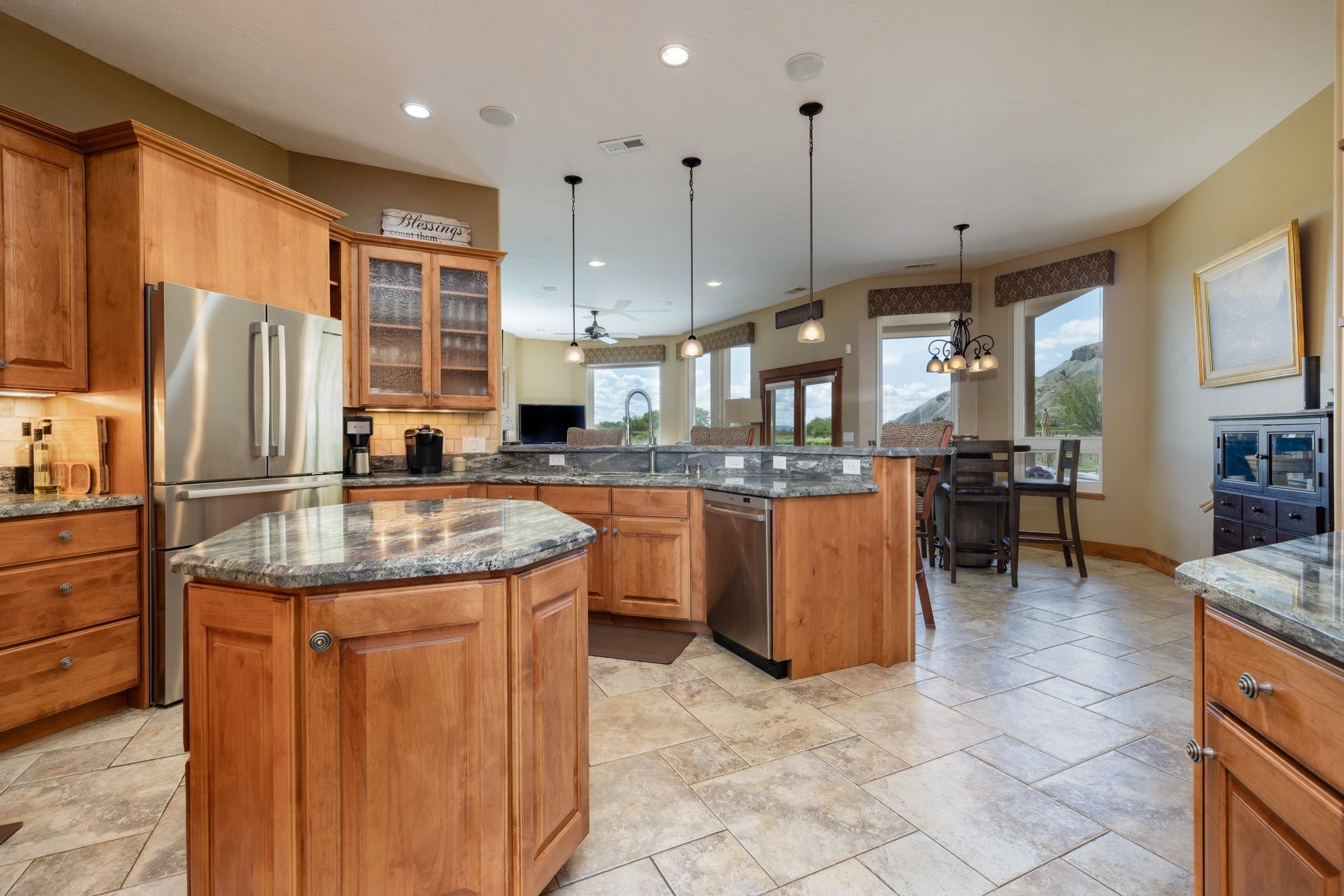759-36 36 3/10 Road Palisade, CO 81526 - Photo 10 of 39 a kitchen with stainless steel appliances granite countertop a sink a stove and a refrigerator