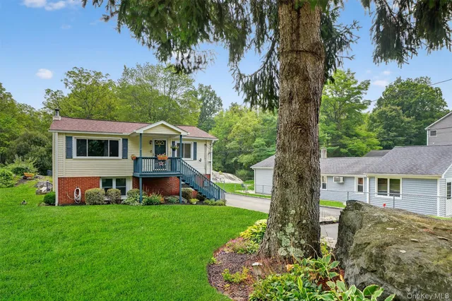 a front view of house with yard and green space