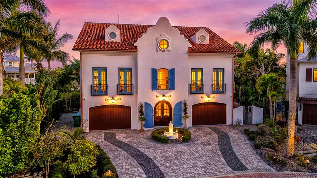 513 Villa Rosa Way Anna Maria, FL 34216 - Photo 1 of 57 a front view of house with yard and outdoor seating