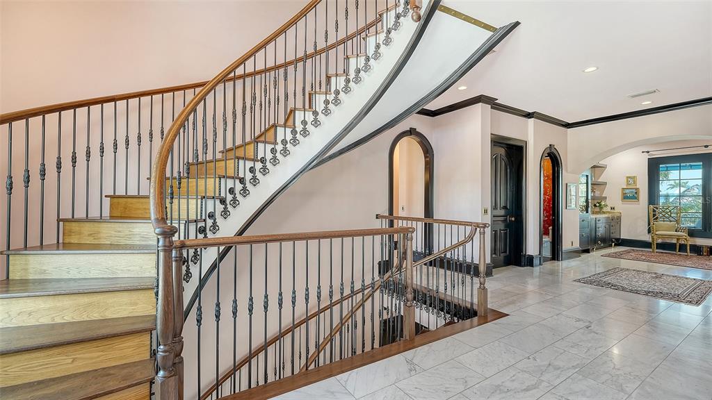 513 Villa Rosa Way Anna Maria, FL 34216 - Photo 11 of 57 a view of entryway with wooden floor and stairs